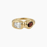 Solid gold sculptural ring featuring a clear rectangular stone and a round deep brown gemstone set in an organic molten-style band. Designed for women seeking a modern statement ring that balances structure and softness, ideal for everyday wear or special occasions and for those wanting a distinctive alternative to traditional gemstone rings.