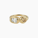 Solid gold sculptural ring with a clear rectangular stone paired with a round champagne-coloured gemstone in an asymmetrical organic setting. Created for women who want a refined yet contemporary statement ring, offering warmth, individuality, and a modern alternative to classic diamond styles.