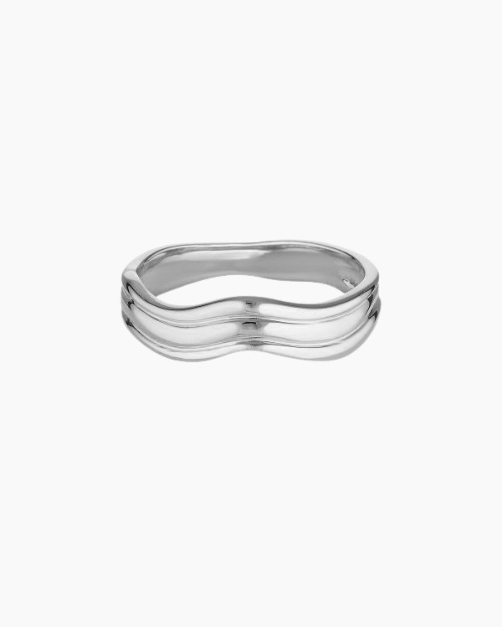 Silver Adeline wave ring on a white background, showing a smooth sculptural band with a curved fluid shape for shoppers looking for an everyday stainless steel ring that feels minimal, polished and easy to style.