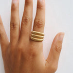 Dara gold ribbed statement ring worn on the finger, showing the chunky layered design for customers wanting a comfortable stainless steel statement ring for everyday styling and jewellery stacking.