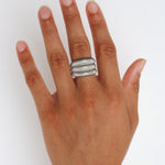 Dara silver ribbed statement ring worn on the finger, showing the wide sculptural shape for shoppers looking for a durable stainless steel ring that is easy to style day or night.