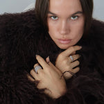 Model wearing the Dara silver ribbed statement ring with elevated everyday jewellery styling, ideal for customers looking for inspiration on how to wear a bold stainless steel ring with a polished outfit.