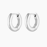Pair of polished silver hoop earrings displayed on a white background, featuring a chunky rounded profile with a hinged clasp closure. Designed for women seeking everyday silver hoop earrings that are secure, comfortable, and easy to style, these minimalist hoops provide a timeless solution for elevating daily outfits with durable sterling silver jewellery suitable for work, casual wear, and layering with other silver earrings.