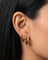 Model wearing SELENE rounded gold hoop earrings in small, medium and large sizes. Polished sterling silver hoops with micron 18k gold plating styled as a layered ear stack for timeless everyday jewellery looks and elevated minimal styling.