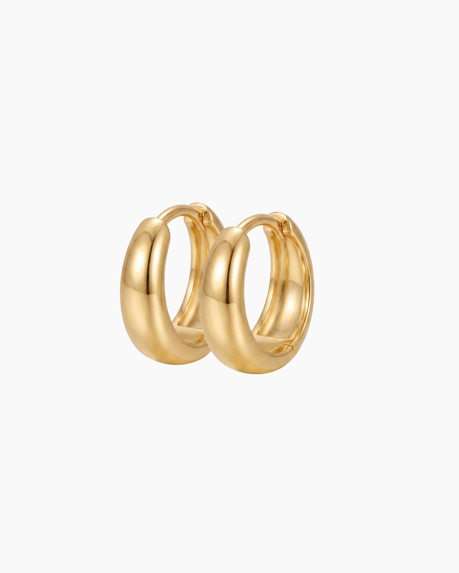 SELENE rounded gold hoop earrings on a white background. Classic chunky hoop earrings crafted from sterling silver with micron 18k gold plating, designed for lightweight everyday wear, minimal jewellery styling and timeless layered looks.