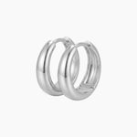 SELENE rounded silver hoop earrings on a white background with a polished chunky dome design. Sterling silver hoop earrings with rhodium plating, designed for comfortable everyday wear, sensitive ears, minimalist styling and classic layered jewellery looks.