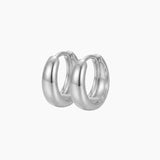 SELENE rounded silver hoop earrings on a white background featuring a polished chunky dome silhouette. Sterling silver hoop earrings with rhodium plating, perfect for everyday wear, sensitive ears, minimalist jewellery styling and layered hoop looks.