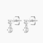 Close-up product image of silver pearl and crystal stud earrings, featuring a small cubic zirconia stud with a dangling freshwater pearl charm on a sterling silver base. Designed for women seeking elegant silver stud earrings for everyday wear, weddings, or special occasions, this image highlights hypoallergenic pearl earrings that offer a refined, lightweight option for sensitive ears, first or second piercings, and minimalist jewellery styling.