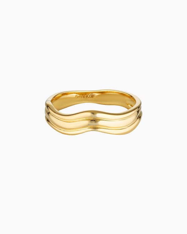 Product image showing the Adeline gold wave ring, a minimalist 14K gold-filled ring with a smooth, organic wave design on a white background. Designed for those looking for a modern gold stacking ring or everyday gold ring, this piece offers a comfortable, water-safe alternative to traditional straight bands, ideal for daily wear, minimalist styling, and effortless ring layering.