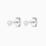Product image of a pair of silver-toned cubic zirconia stud earrings shown on a white background, featuring small round stones in a classic claw setting with straight posts and butterfly backs. Designed for women seeking minimalist silver stud earrings for everyday wear, these studs suit first or second lobe piercings and help solve the need for subtle, comfortable jewellery that pairs easily with layered ear stacks and sensitive ears.