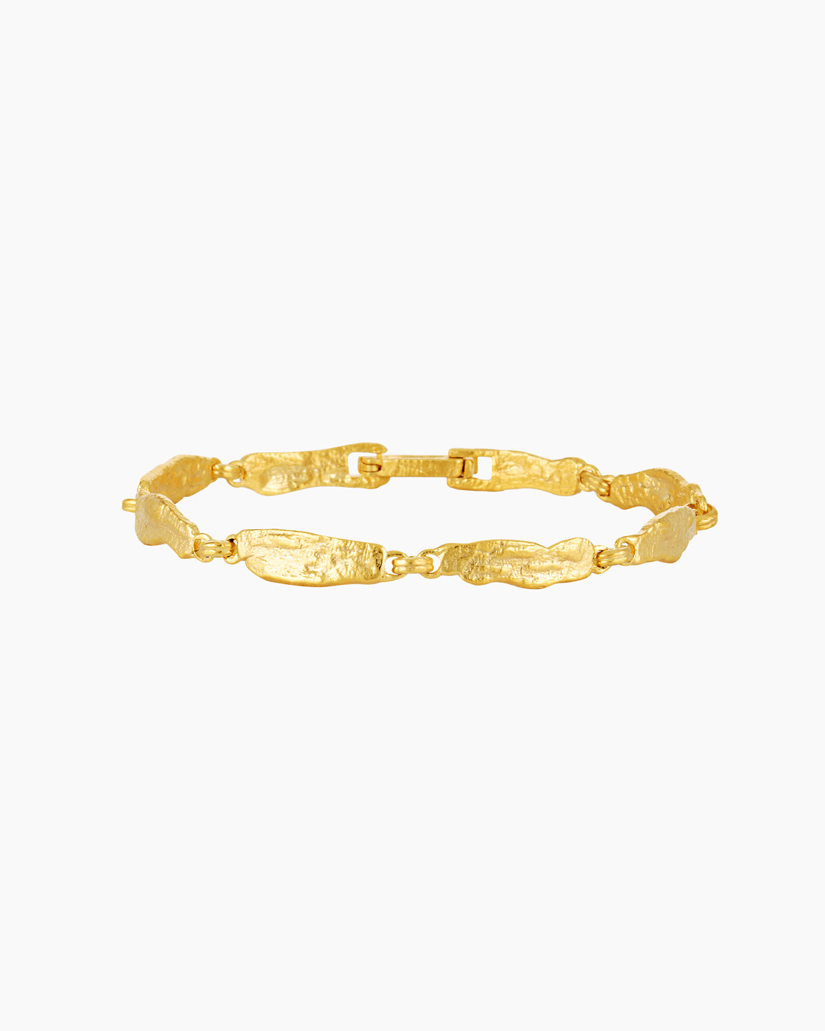 Studio product image of a slim gold bracelet with textured, organically shaped links arranged in an oval on a white background. The photo clearly shows the bracelet’s full design, clasp detail, warm gold finish, and handcrafted surface texture. Designed for women looking for an elegant, everyday gold bracelet with subtle character, this image helps customers clearly understand the bracelet’s style, link shape, and overall proportion when worn.