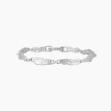 Studio product image of a slim silver bracelet with textured, organically shaped links arranged in an oval on a white background. The photo clearly shows the bracelet’s full design, clasp detail, cool silver tone, and hammered surface texture. Designed for women looking for an elegant, everyday silver bracelet with subtle detail, this image helps customers understand the bracelet’s style, link shape, and overall proportion when worn.