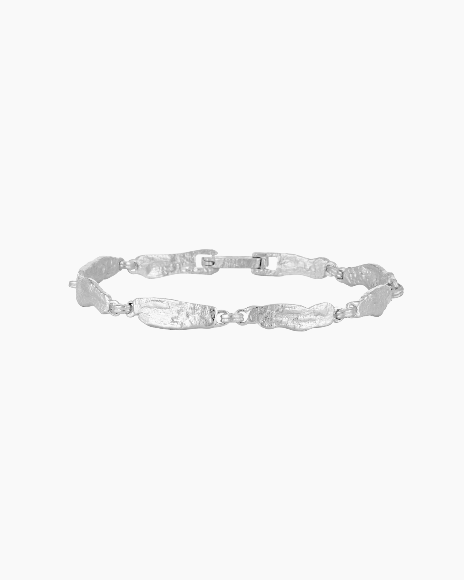 Studio product image of a slim silver bracelet with textured, organically shaped links arranged in an oval on a white background. The photo clearly shows the bracelet’s full design, clasp detail, cool silver tone, and hammered surface texture. Designed for women looking for an elegant, everyday silver bracelet with subtle detail, this image helps customers understand the bracelet’s style, link shape, and overall proportion when worn.