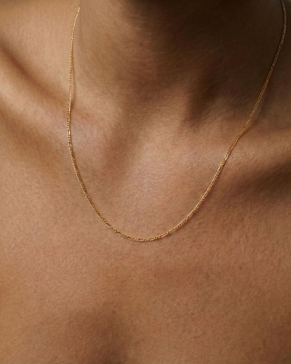 Gold filled figaro chain necklace worn on model, featuring alternating elongated and short links for a refined everyday layered jewellery look by House of Slani.