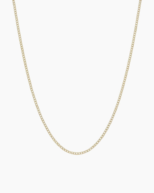 Dainty gold filled curb chain necklace by House of Slani displayed on a white background, featuring fine polished links designed for layering or adding charms.