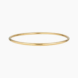 Minimalist slim gold bangle bracelet photographed on a white background, featuring a smooth polished finish. Designed for women seeking a timeless everyday gold bracelet that layers easily with other bangles or can be worn alone for a clean, understated look. Ideal for those looking for durable, low-maintenance gold jewellery that is water safe, lightweight, and suitable for daily wear.