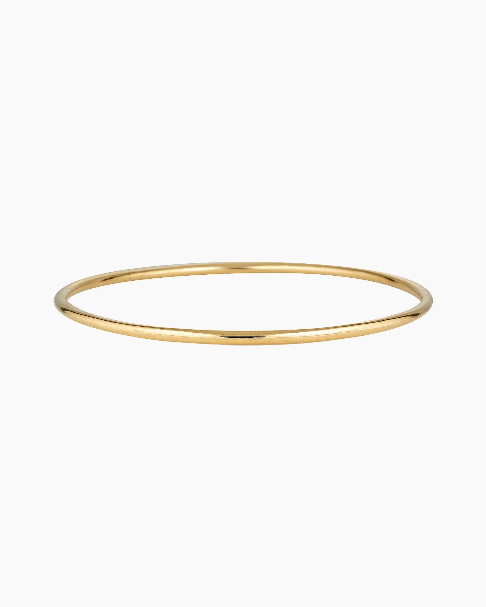 Minimalist slim gold bangle bracelet photographed on a white background, featuring a smooth polished finish. Designed for women seeking a timeless everyday gold bracelet that layers easily with other bangles or can be worn alone for a clean, understated look. Ideal for those looking for durable, low-maintenance gold jewellery that is water safe, lightweight, and suitable for daily wear.