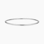 Minimalist slim silver bangle bracelet photographed on a white background, featuring a smooth polished finish. Designed for women seeking a timeless everyday silver bracelet that layers easily with other bangles or can be worn alone for a clean, understated look. Ideal for those looking for durable, low-maintenance  silverjewellery that is water safe, lightweight, and suitable for daily wear.