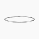 Minimalist slim silver bangle bracelet photographed on a white background, featuring a smooth polished finish. Designed for women seeking a timeless everyday silver bracelet that layers easily with other bangles or can be worn alone for a clean, understated look. Ideal for those looking for durable, low-maintenance  silverjewellery that is water safe, lightweight, and suitable for daily wear.