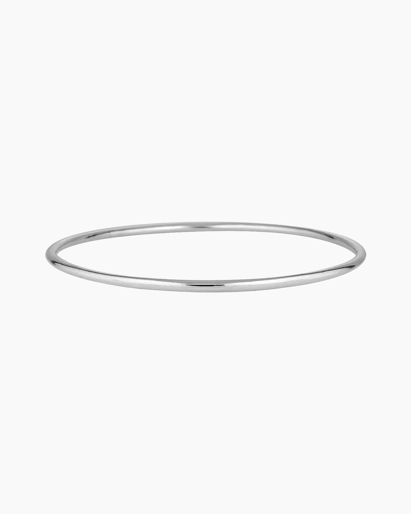 Minimalist slim silver bangle bracelet photographed on a white background, featuring a smooth polished finish. Designed for women seeking a timeless everyday silver bracelet that layers easily with other bangles or can be worn alone for a clean, understated look. Ideal for those looking for durable, low-maintenance  silverjewellery that is water safe, lightweight, and suitable for daily wear.