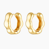 Close-up product image of Bella gold hoop earrings on a white background, featuring a sculpted organic shape with a polished finish. This image is for women looking for elevated gold hoop earrings that add interest to a minimal outfit and offer a refined alternative to classic smooth hoops for everyday wear.