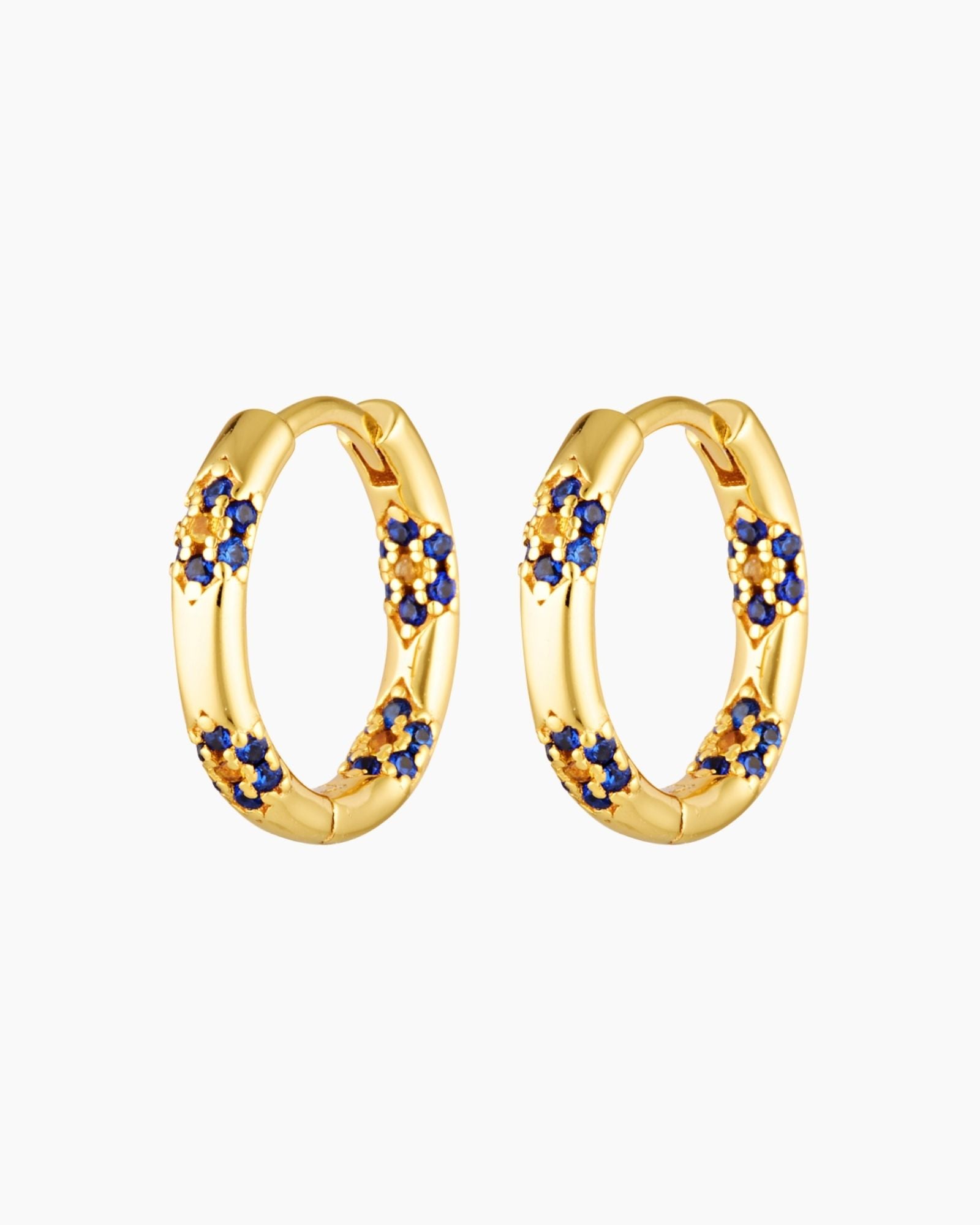 A pair of gold plated hoop earrings adorned with blue and yellow cubic zirconia stones in a floral pattern.