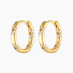 A pair of gold-colored hoop earrings adorned with cubic zirconia stones in a floral pattern.