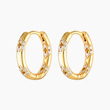 A pair of gold-colored hoop earrings adorned with cubic zirconia stones in a floral pattern.