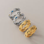 A pair of medium-sized hoop earrings with cubic zirconia, available in gold and rhodium colors.