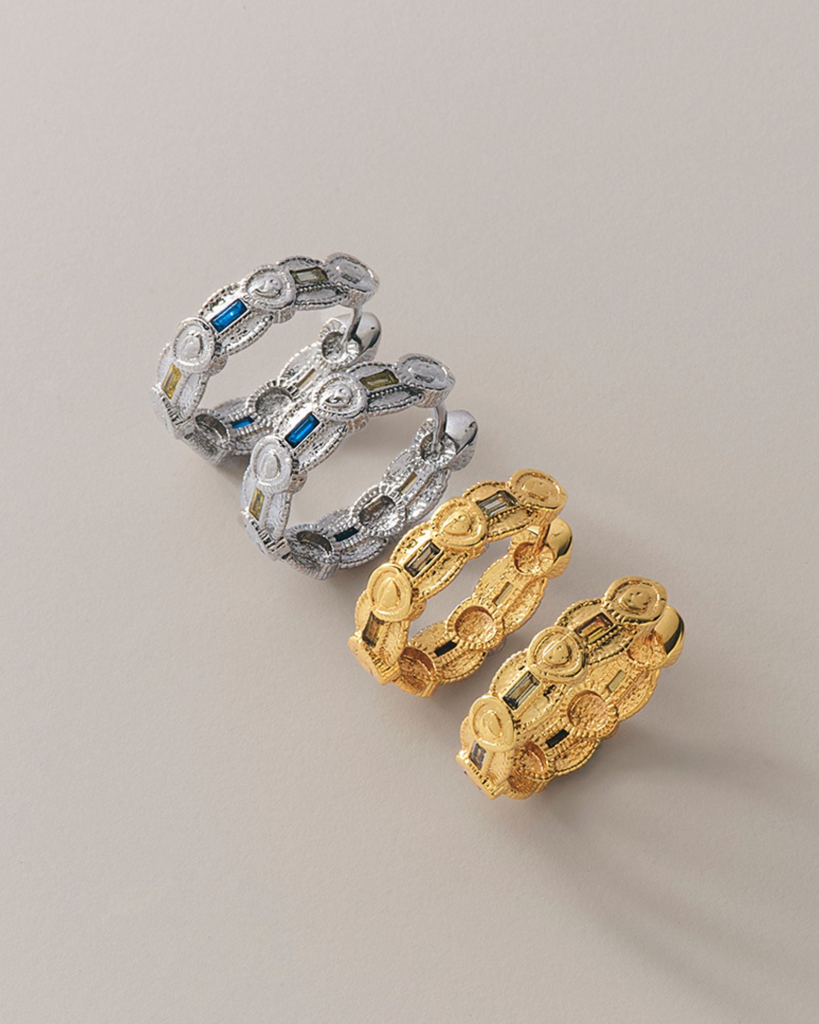 A pair of medium-sized hoop earrings with cubic zirconia, available in gold and rhodium colors.