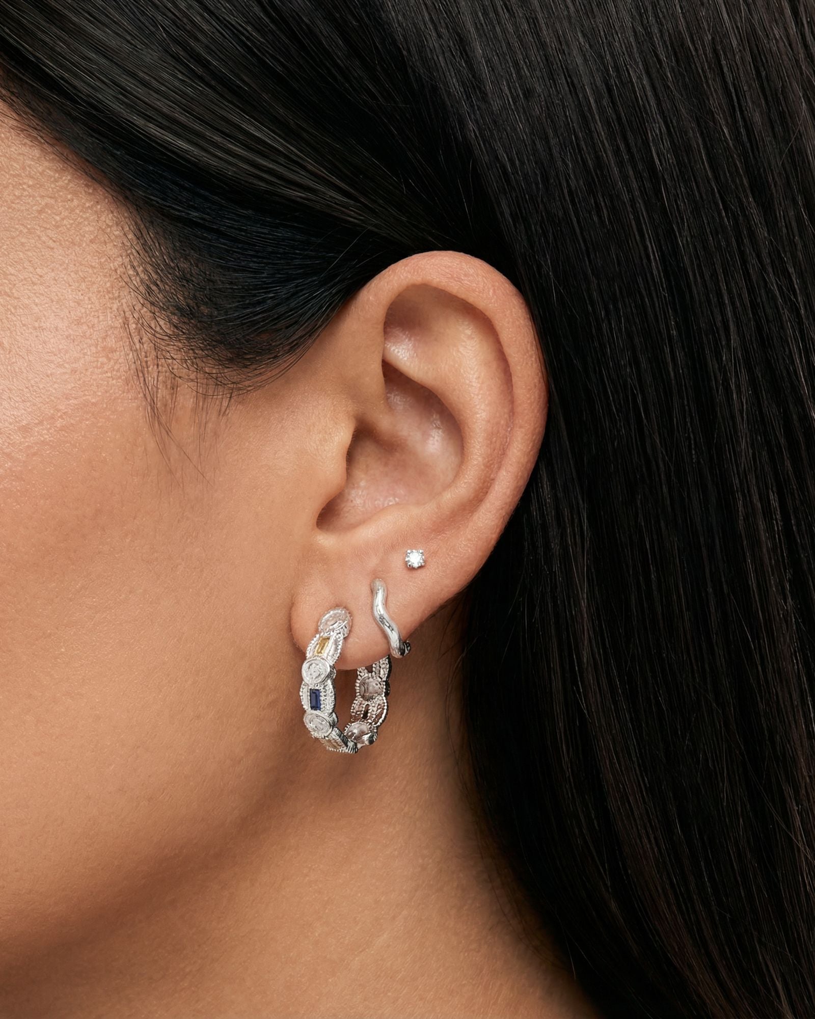 euro summer vintage inspired medium sized hoops with different gemstones like blue, canary yellow and white, dainty wavy textured huggie hoops with a small dainty white square cut gemstone in silver