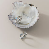 medium sized silver statement hoops with differnet gemstones colours in blue, yellow and light white 
