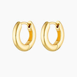 Pair of polished gold hoop earrings displayed on a white background, featuring a chunky rounded silhouette with a hinged clasp closure. Designed for women seeking everyday gold hoop earrings that are easy to wear, secure, and versatile, these minimalist hoops offer a timeless solution for elevating daily outfits with durable, classic jewellery suitable for work, casual wear, and layering with other gold earrings.