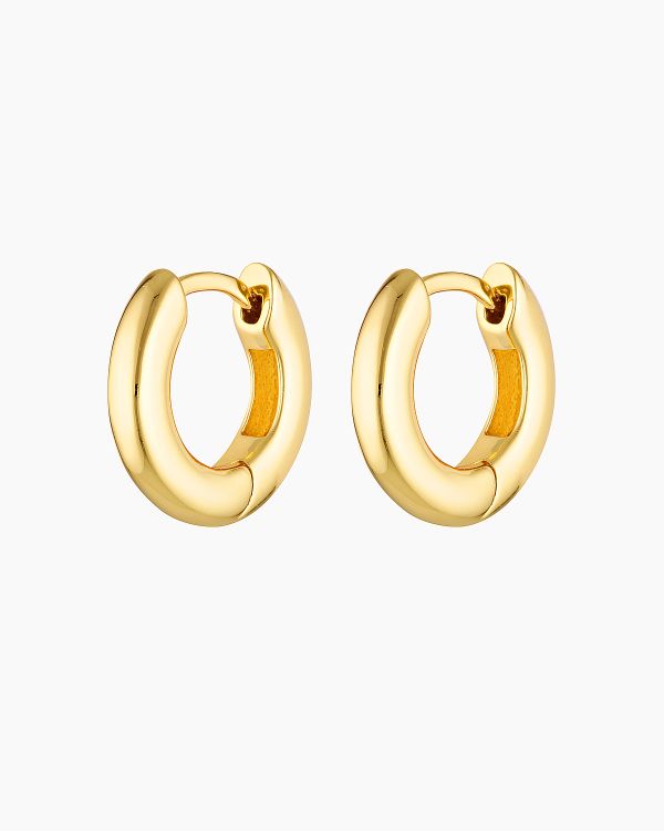 Pair of polished gold hoop earrings displayed on a white background, featuring a chunky rounded silhouette with a hinged clasp closure. Designed for women seeking everyday gold hoop earrings that are easy to wear, secure, and versatile, these minimalist hoops offer a timeless solution for elevating daily outfits with durable, classic jewellery suitable for work, casual wear, and layering with other gold earrings.