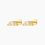 Pair of gold flat back stud earrings featuring three round cubic zirconia stones in a minimalist cluster design, shown on a white background. Designed for people with cartilage, helix or lobe piercings who want comfortable, hypoallergenic flat back earrings that sit flush to the ear and are suitable for everyday wear, sleeping, and sensitive ears.