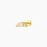 Studio product image of a single gold flat back stud earring featuring three cubic zirconia stones in a minimalist setting. Designed for cartilage, helix, and lobe piercings, this flat back earring offers a low-profile, comfortable fit ideal for sensitive ears, sleeping, and everyday wear while adding subtle sparkle to a curated ear stack.