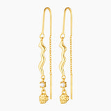 thread gold earring with organic charm with attached white gem stone and a gold nugget