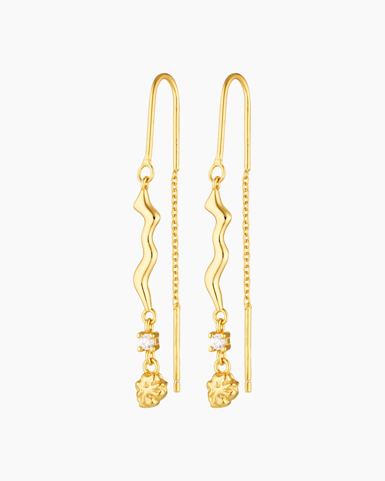 thread gold earring with organic charm with attached white gem stone and a gold nugget