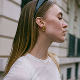 Gold Sofia Necklace with dainty CZ pendant styled on model in minimalist streetwear outfit.