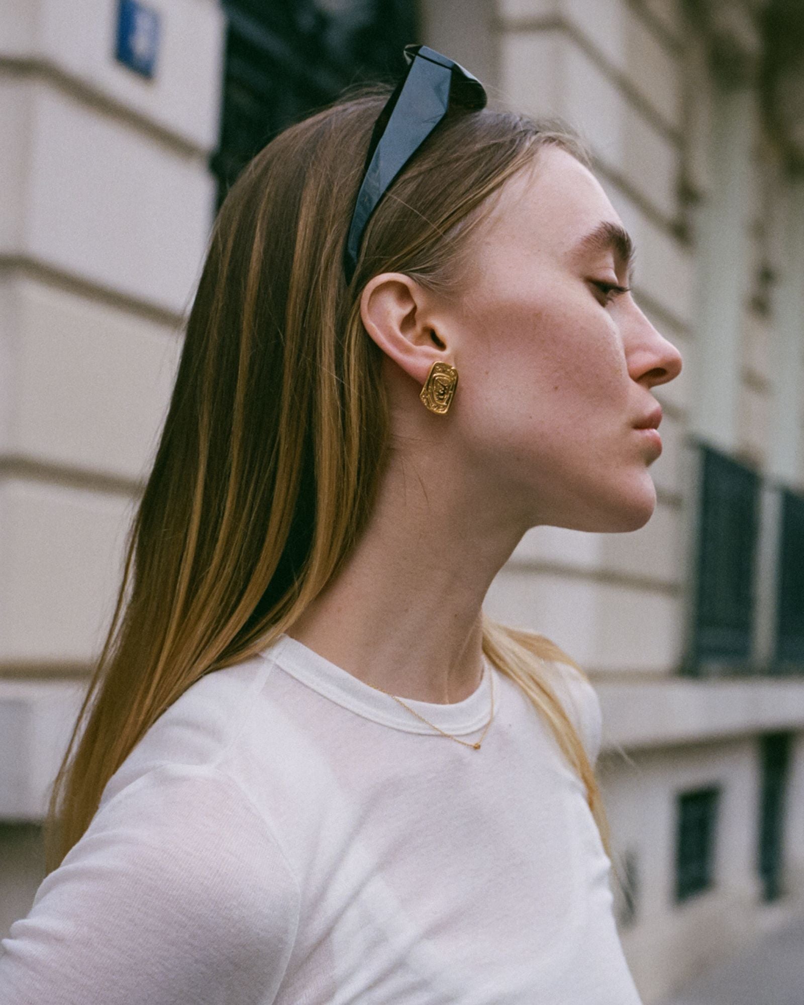 Gold Sofia Necklace with dainty CZ pendant styled on model in minimalist streetwear outfit.