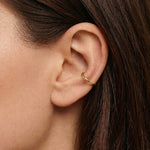 Minimalist gold ear cuff worn on the cartilage of a woman’s ear, shown in a close-up side profile with smooth polished finish. Designed for women who want a clean, modern ear stack without a piercing, this no-piercing ear cuff offers an easy way to add subtle gold jewellery to everyday looks while remaining lightweight, comfortable, and suitable for sensitive skin.