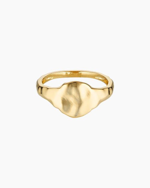 Product image of a flat organic gold signet ring with a softly sculpted face, shown on a white background. Designed for women seeking a minimalist gold signet ring for everyday wear, this image highlights a modern statement ring that offers a refined alternative to traditional signet styles and is easy to style daily.