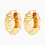 Gold statement hoop earrings with bold sculptural layered texture, 18k gold plated design photographed on a white background.