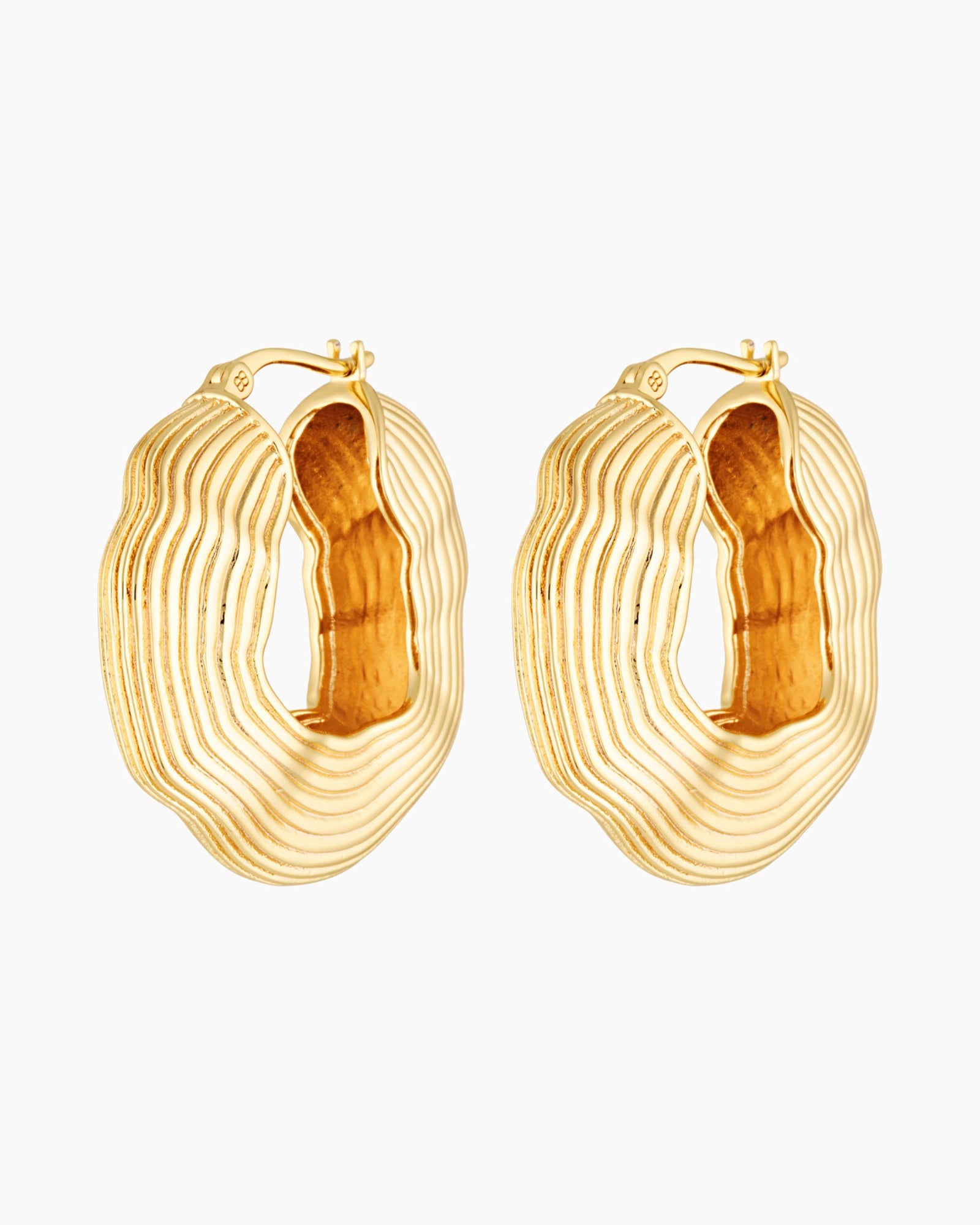 Gold statement hoop earrings with bold sculptural layered texture, 18k gold plated design photographed on a white background.