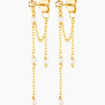 Gold chain earrings with pearl drops on a white background