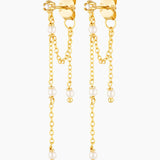 Gold chain earrings with pearl drops on a white background