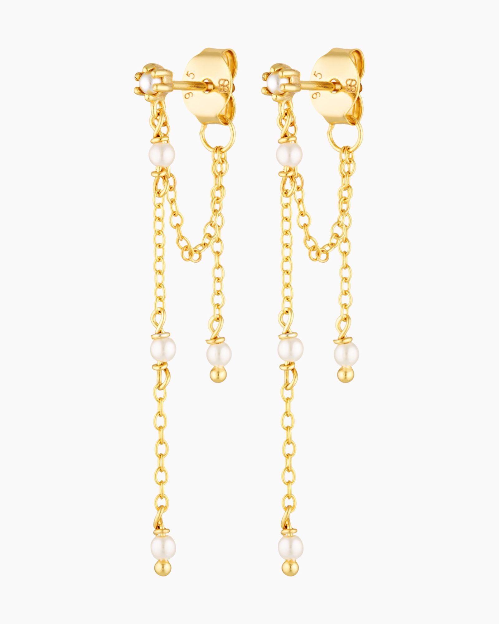 Gold chain earrings with pearl drops on a white background