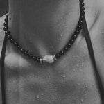 black beaded onyx necklace in water
