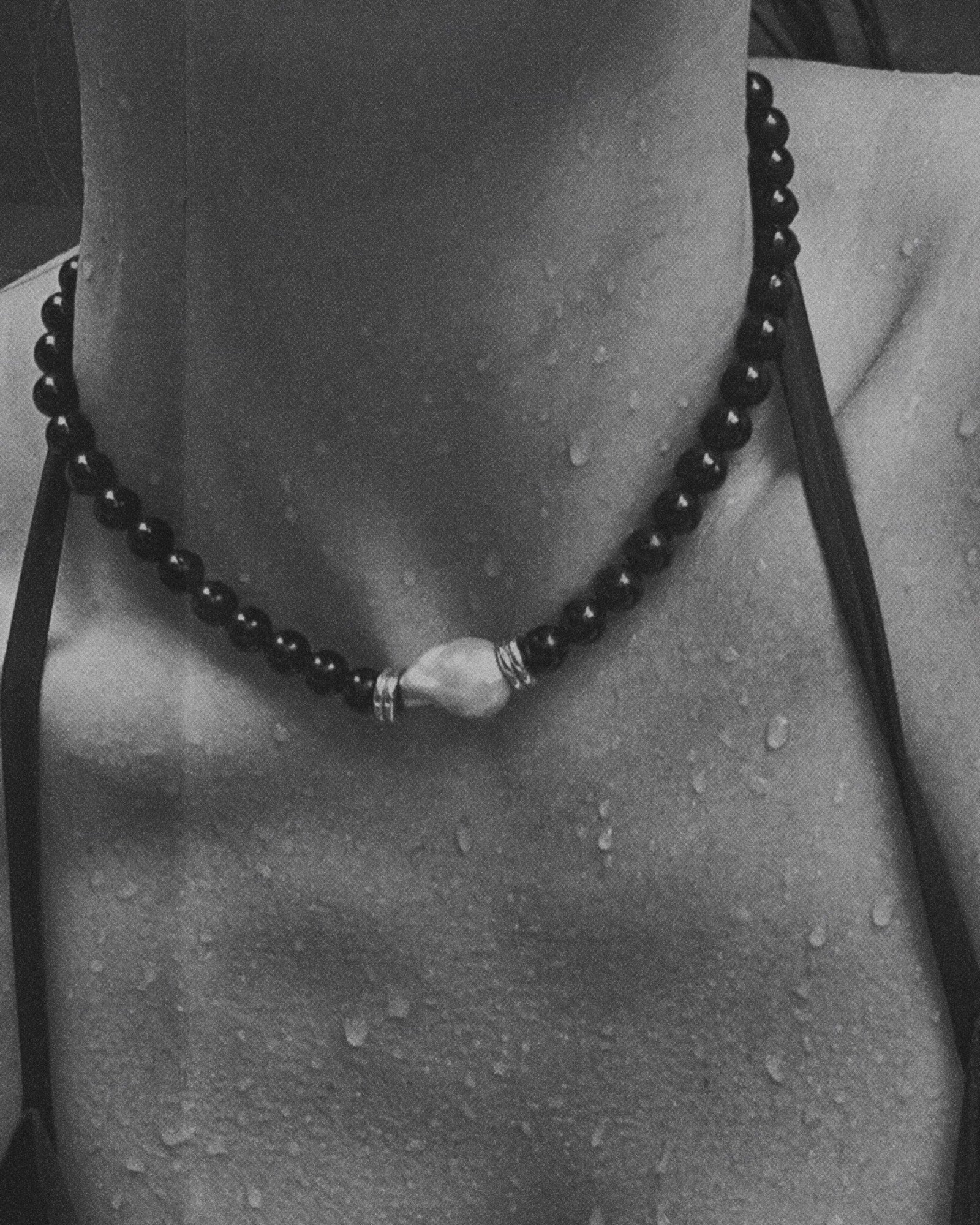 black beaded onyx necklace in water
