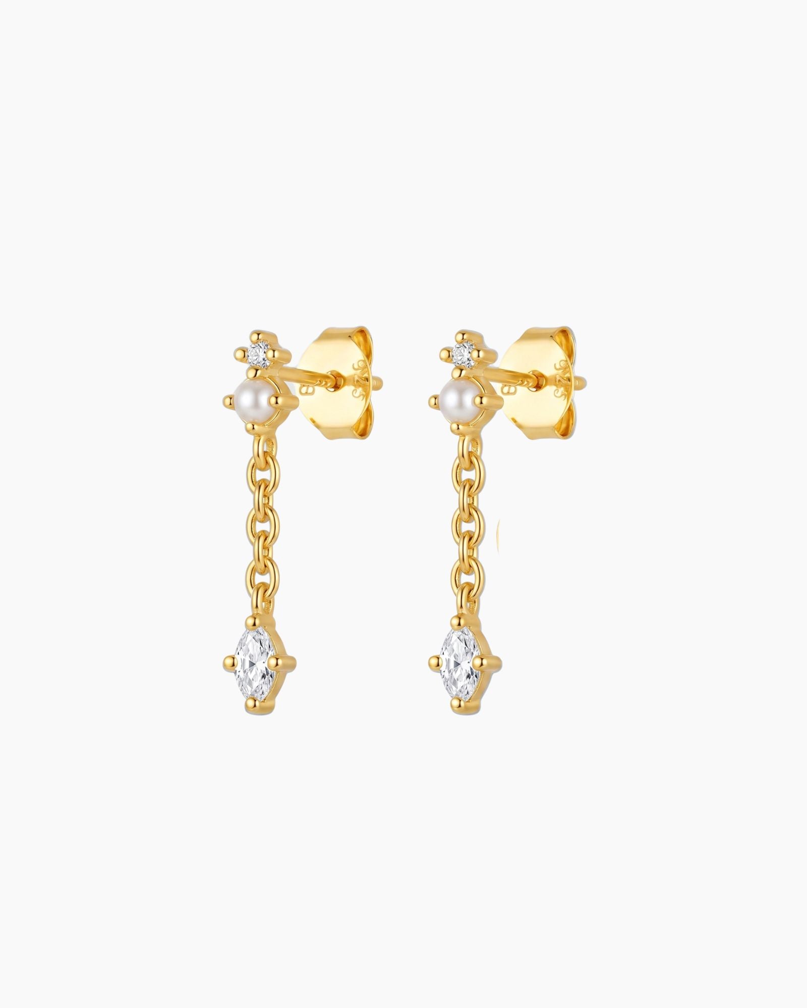 18K gold plated pearl drop earrings featuring a marquise-cut cubic zirconia stone suspended from a fine chain. Feminine lightweight gold earrings for women looking for timeless everyday jewellery, bridal earrings, special occasion accessories or elegant gold pearl earrings.